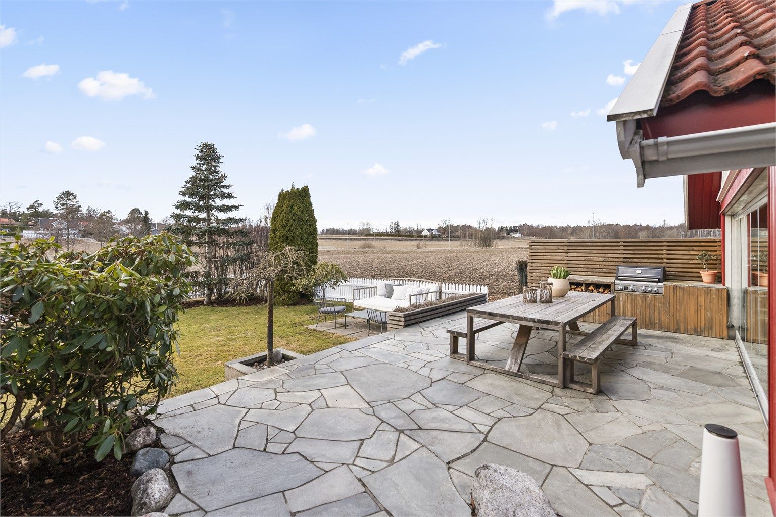 En usjenert og solrik uteplass med utsikt over det åpne landskapet.