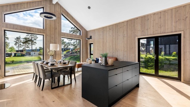 Verandadør på begge langveggene i stua kan åpnes helt så ute og inne flyter i hverandre.