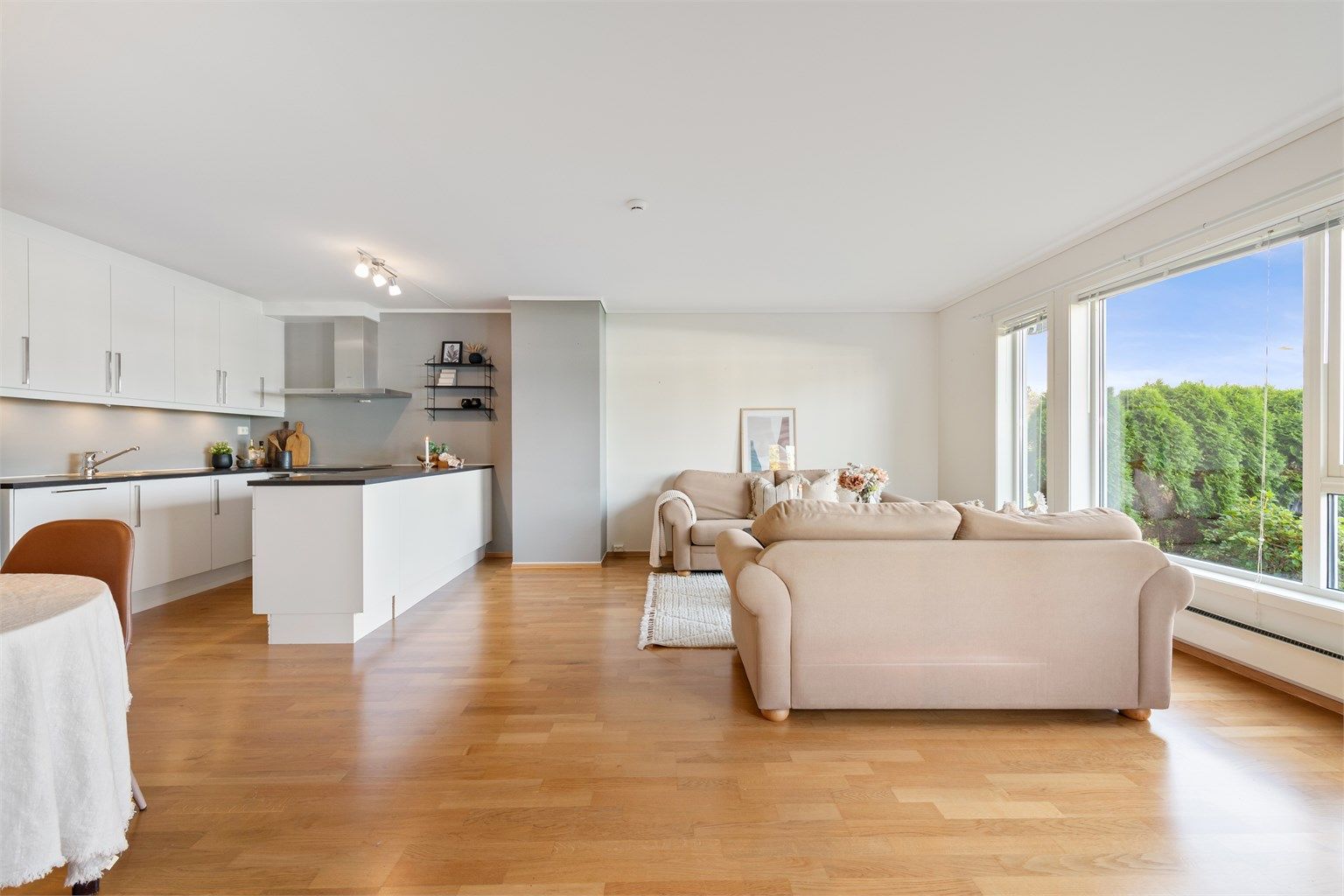 Stue og kjøkken i åpen løsning med praktisk kjøkkenøy mot stuedelen