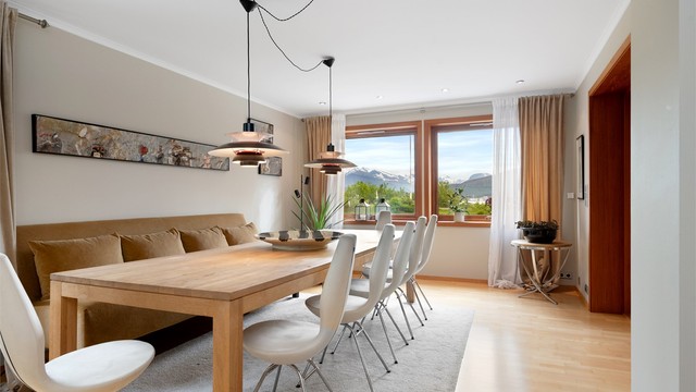 Spisestuen har god plass til langbord for sosiale sammenkomster og vinduer mot landskapet.