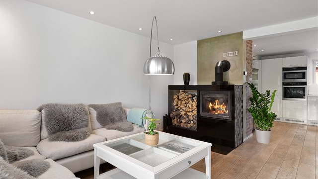 Peisovn med vednisje gir god varme og hygge ved spiseplassen samt sofaområdet.