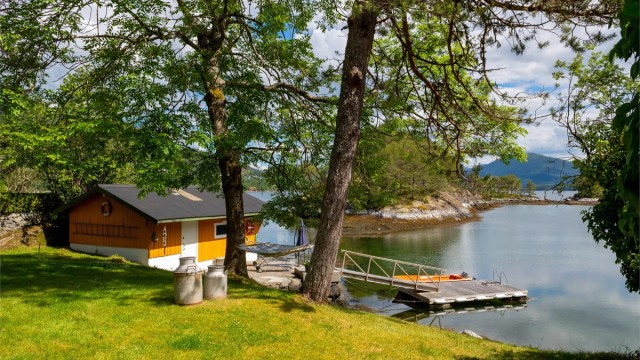 Naust og flytebrygge sett fra hagen