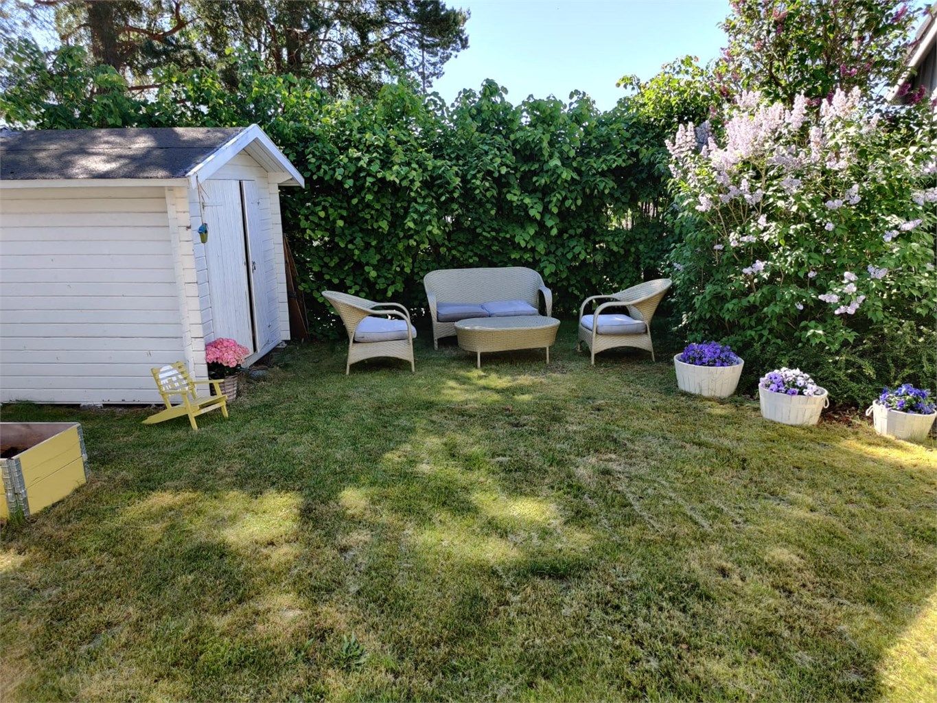 Den hyggelige hagen byr på gode solforhold og med plass for både hyggelige sittegrupper, blomsterbed og dyrking i plantekasser.