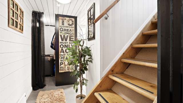 Tretrappen leder ned til kjelleretasjen. Romslig garderobe/bod ved vaskerom.