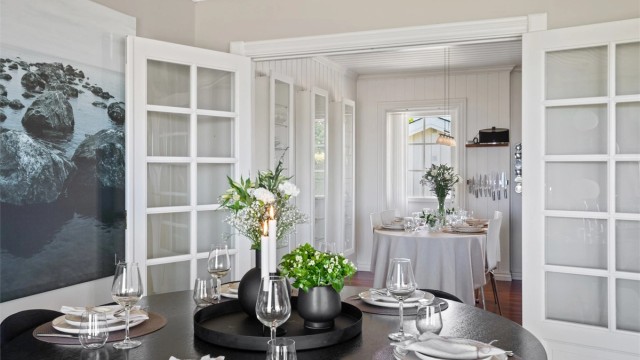 Tofløyede dører leder inn til kjøkkenet, og det er ellers åpent mot gangen.