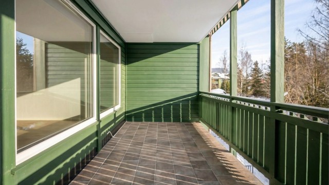 Balkongen har flislagt gulv og god plass for utemøbler.