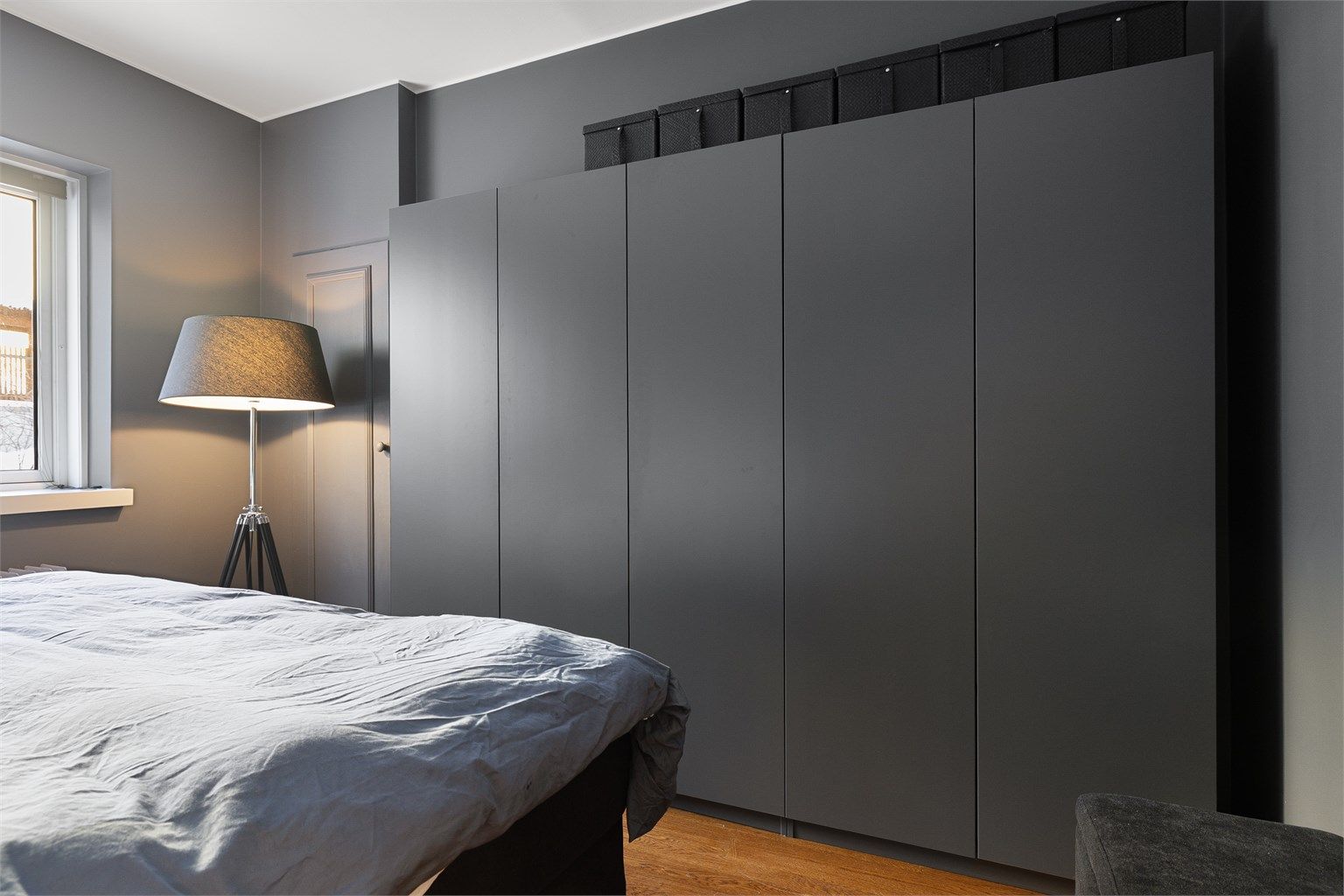 En hel vegg med garderobeskap samt tilgang til et kott gir rikelig med oppbevaringsplass.