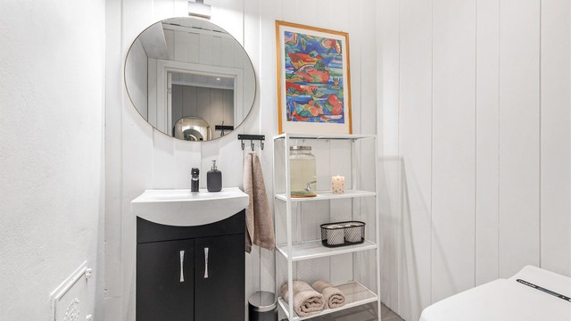 Toalettrom fra 2022. Gulvflate belagt med fliser og gulvvarme, malt panel på vegger og nedsenket himling med downlights.
