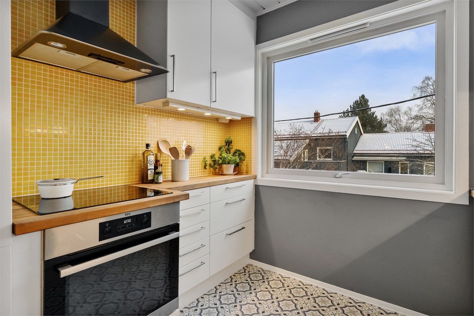 Kjøkkenet er utstyrt med moderne induksjonstopp og integrert stekeovn.