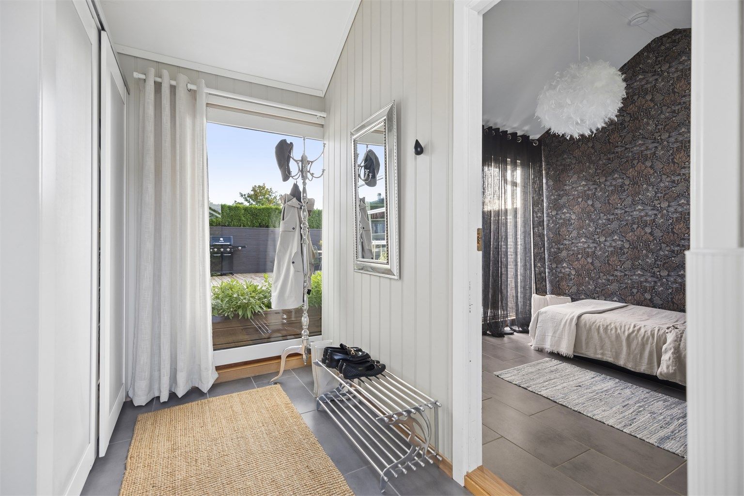 Velkommen inn i en romslig entré med god plass til å henge fra deg yttertøyet i skyvedørsgarderobe. 