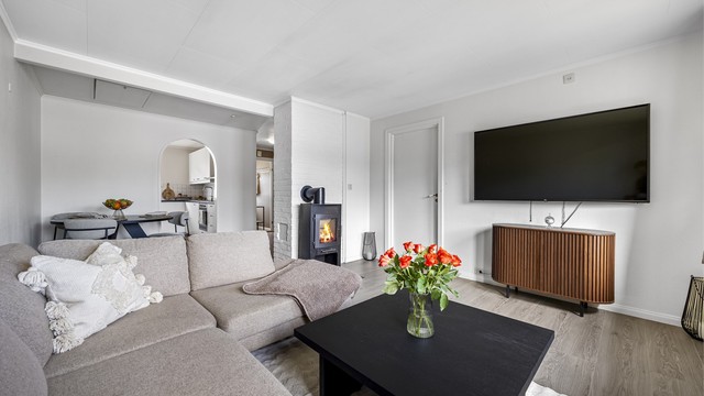 En effektiv vedovn er sentralt plassert i stuen og gir en lun varme.