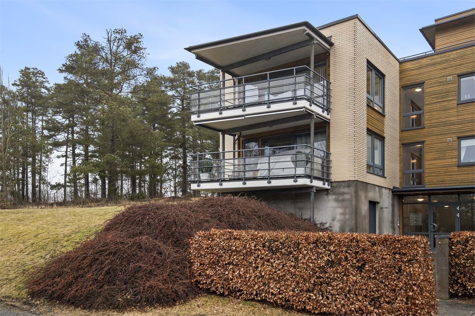 Eiendommen er pent opparbeidet med plen og beplantning.