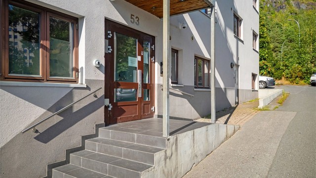 Felles overbygget inngangsparti med videre heis- og trappeadkomst til leilighetens etasjeplan (2. etasje).