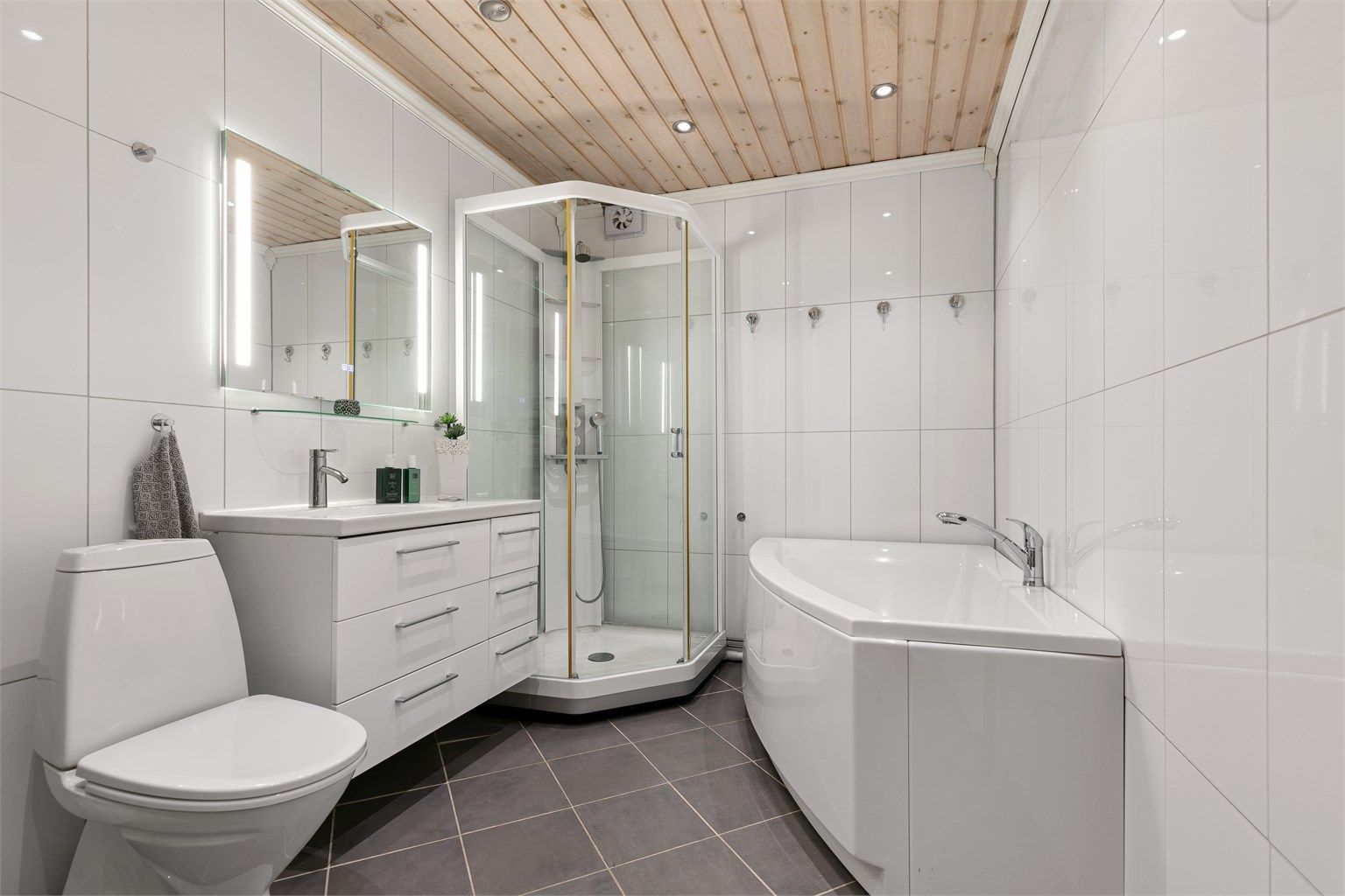 Badet i underetasjen ble pusset opp i 2009 og har moderne overflater og innredning. Her finner du både dusjkabinett med glassdør og et innbydende badekar med dusjløsning.