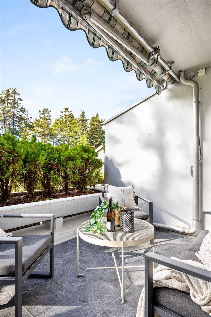 Utsyn mot frodige trær og grøntområder rett utenfor.