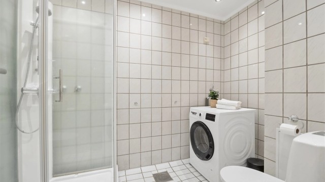 Badet er praktisk innredet med downlights i tak og opplegg for vaskemaskin.