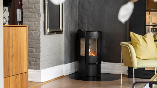 Det er en moderne peisovn i stuen for ekstra varme og hygge på kjølige dager.