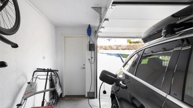 Garasjen er utstyrt med el-billader og har nyere metallport med portåpner