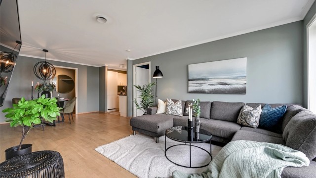 Stuen har gode møbleringsmuligheter for både sofa- og TV-sone, og store vindusflater slipper inn rikelig med dagslys.
