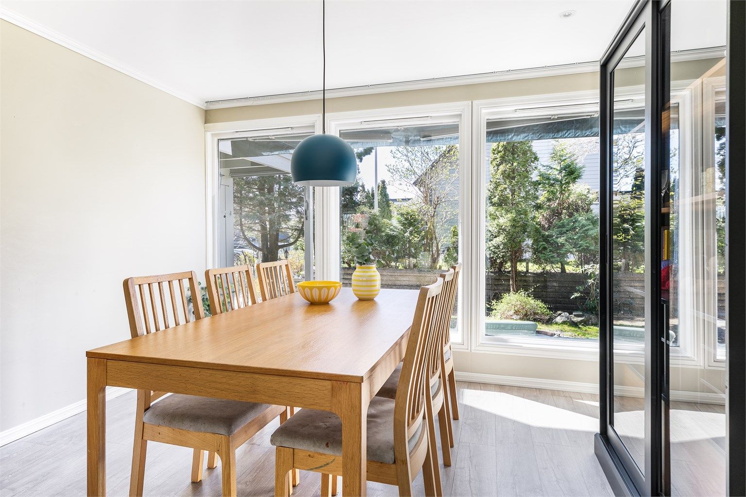 Vinduer med store flater i begge ender fyller stuen med mye naturlig lys. Innsyn er det i praksis ikke.