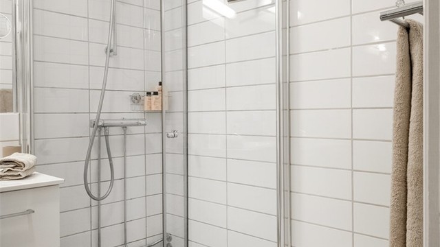 Dusjhjørne med innfellbare glassdører frigjør gulvplass når dusjen ikke er i bruk.