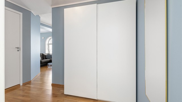 Romslig skyvedørsgarderobe i gangen for effektiv oppbevaring av yttertøy.