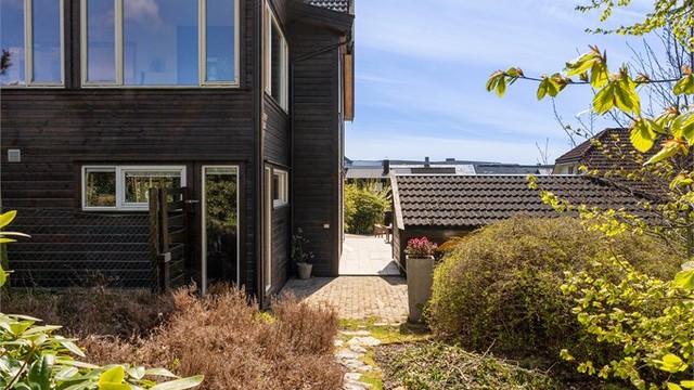 Tomten strekker seg rundt boligen. På baksiden av boligen er det hageflekk og bod.
