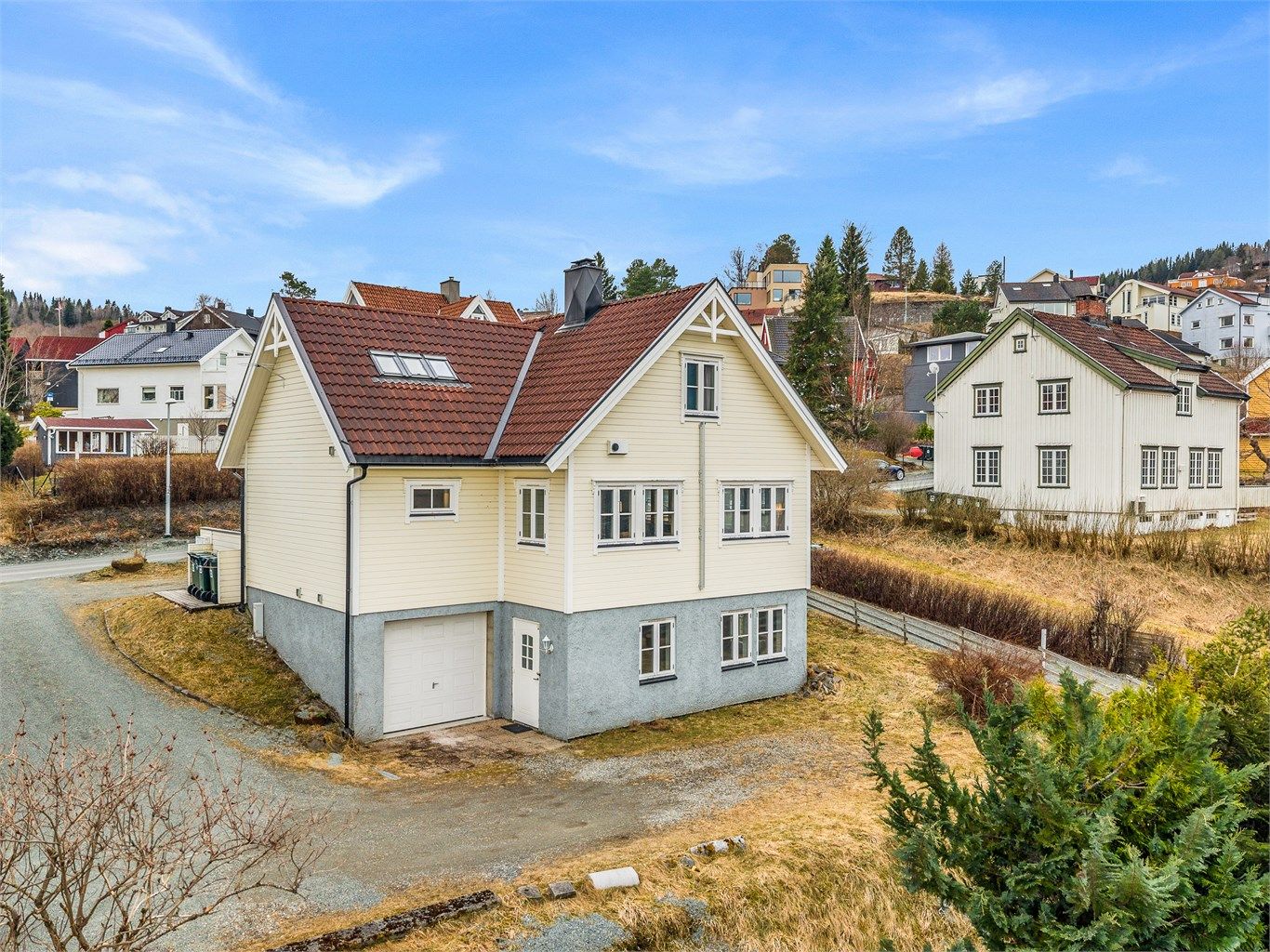 Her får du en flott enebolig over flere plan, med integrert garasje i underetasjen og en beliggenhet som gir både utsyn og privatliv.