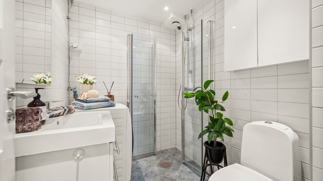 Badet har fliser på vegger og gulv, med elektrisk gulvvarme