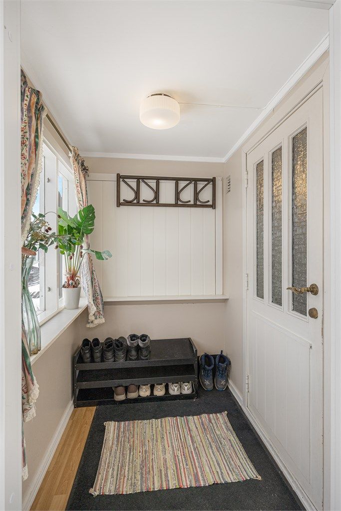 Velkommen inn i en lys entré med overbygget inngangsparti.