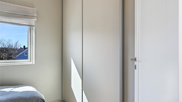 Det fjerde soverommet, også plassert i andre etasje, med plassbygget garderobe.