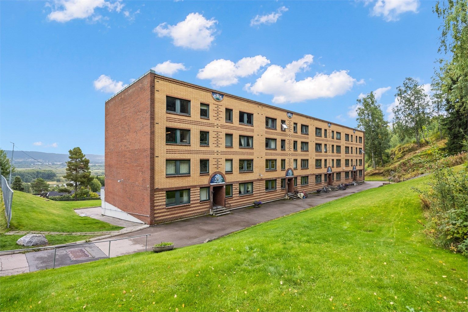 Klassisk teglsteinsfasade i et veletablert og barnevennlig borettslag.