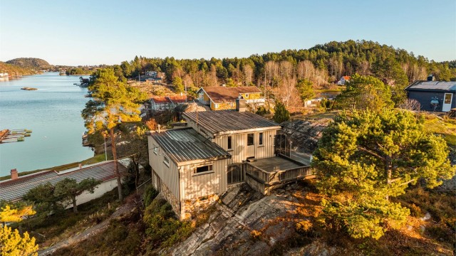 Oversiktsbilde som viser hyttas plassering i forhold til sjøen og nabobebyggelsen.
