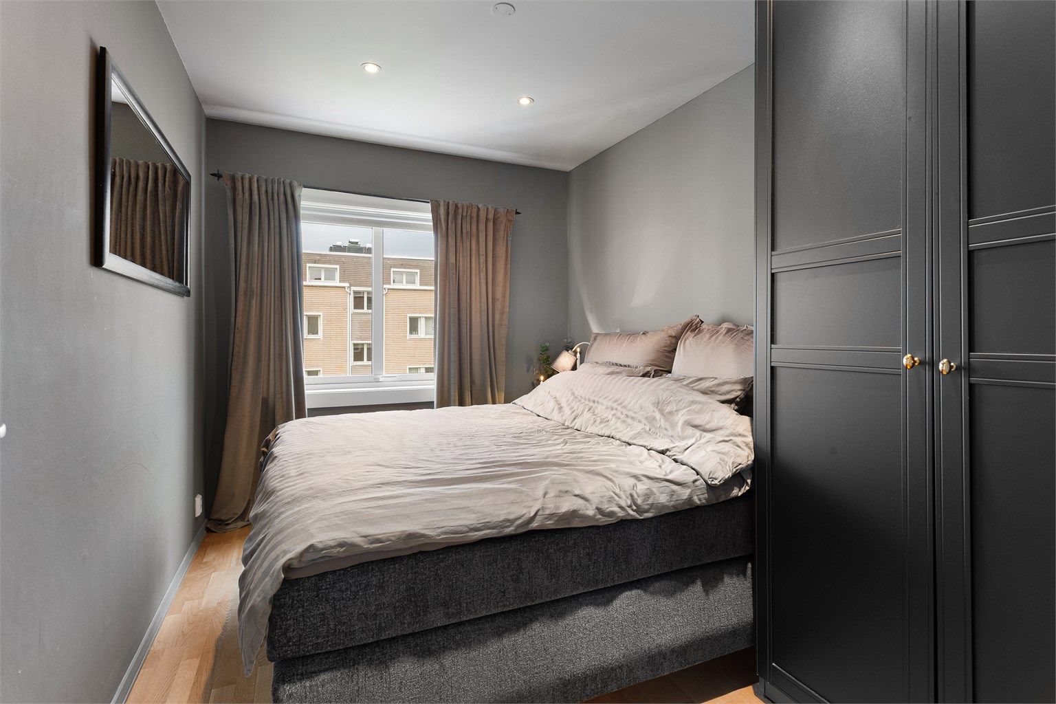 Det ene av leilighetens to soverom, med plass til dobbeltseng og garderobeløsning.