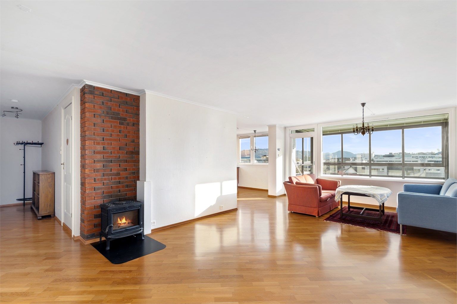 Leiligheten har en åpen løsning mellom stue og kjøkken, som skaper en sosial og luftig atmosfære.