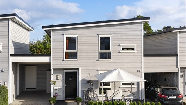 Inngangspartiet har tilhørende carport, utvendig bod og en treplatting i front.