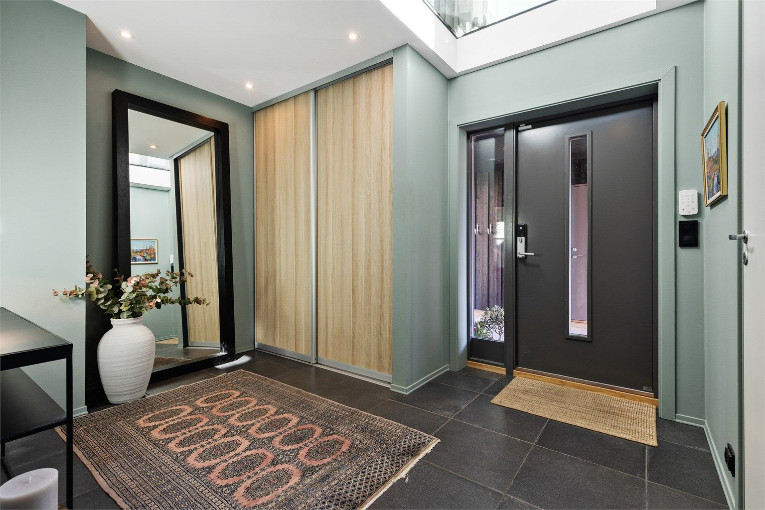 Entreen har god plass til garderobeskap og annen oppbevaring for ytterklær og sko. I entreen er det glasstak opp til stuen i 2.etasje. Dette er en stilig detalj, samtidig som at det skaper romfølelse og gir godt med ekstra lys.