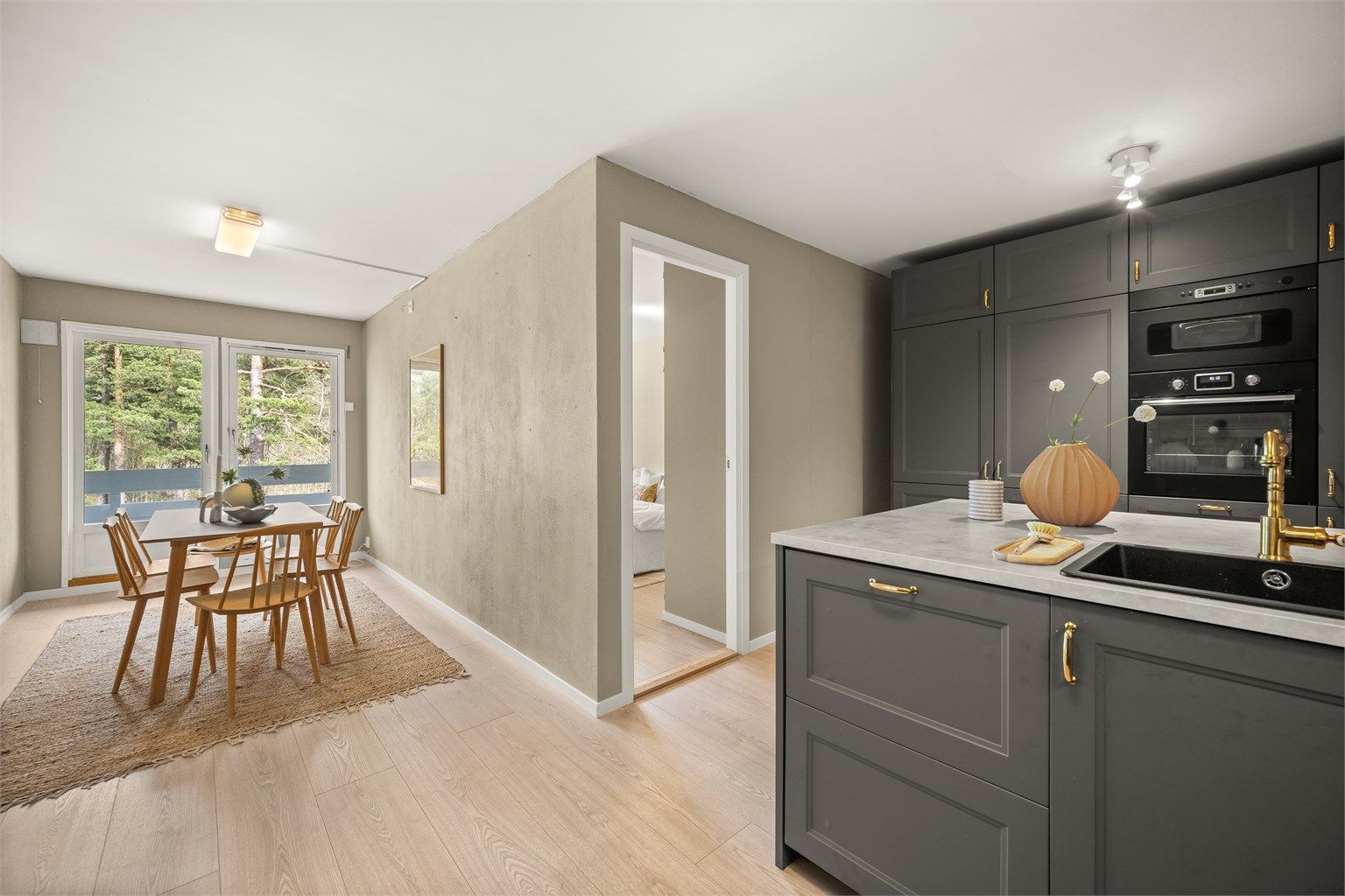 Kjøkkenet fra 2022 er levert av Ikea og har integrerte hvitevarer. Herfra er det utgang til en østvendt balkong. Foto: Martine Eren Jacobsen.