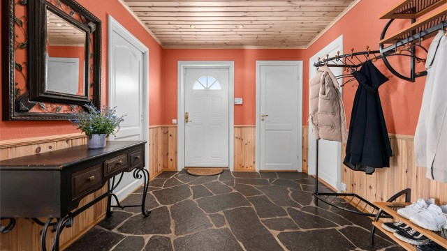 Romslig entré med skifer på gulvet og vannbåren gulvvarme.