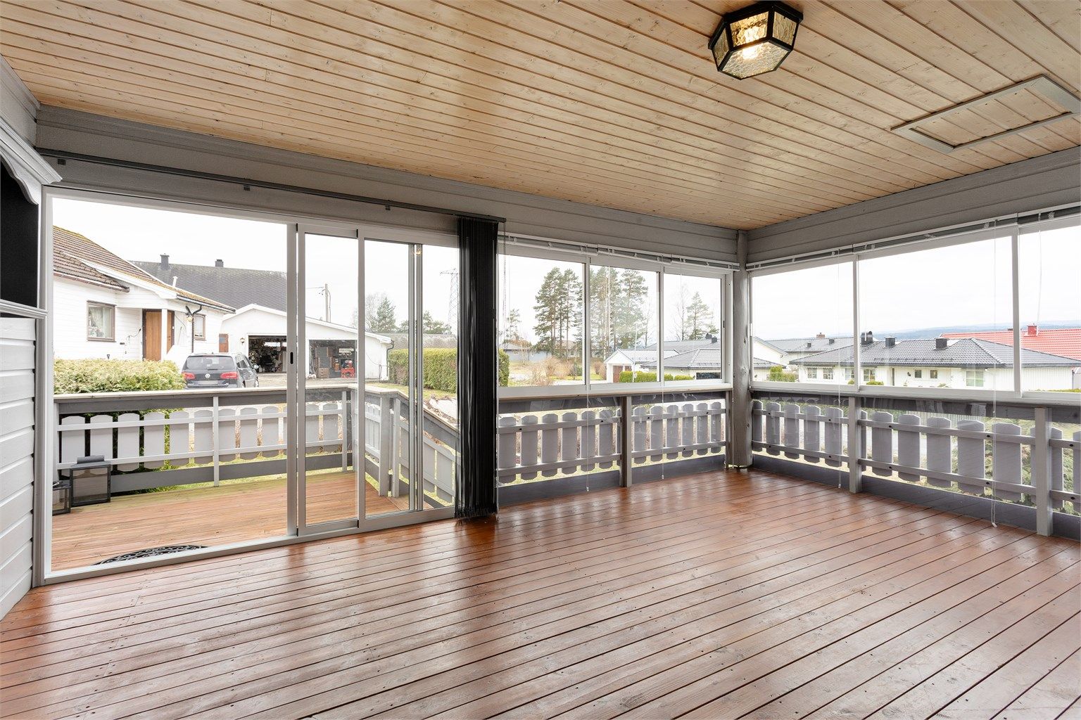 Romslig innglasset veranda med skyvedør ut til terrasse