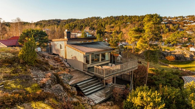 Fritidsboligen er fint tilpasset terrenget og har store terrasseflater i flere nivåer.