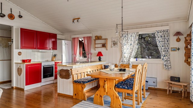 Plassbygget kjøkkeninnredning med ventilator og åpen løsning mot stua.