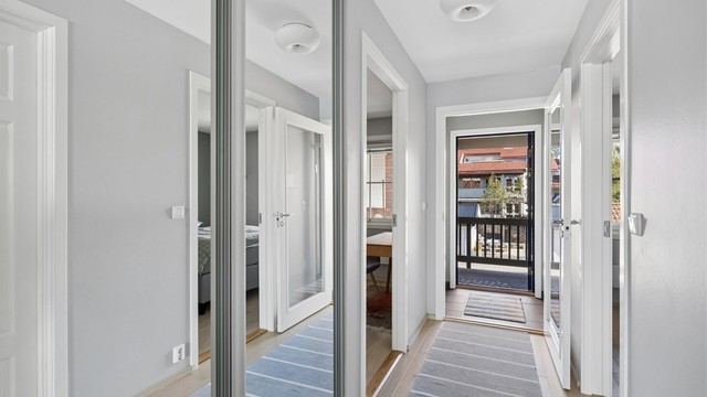 Velkommen inn! Lys og innbydende gang med praktisk skyvedørsgarderobe med speildører.