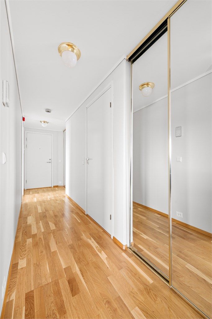 Lys gang med skyvedørsgarderobe med gode oppbevaringsmuligheter 