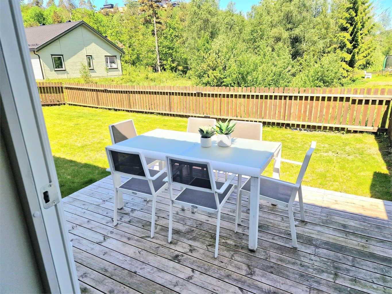 Hagen er opparbeidet med plen og gjerde. Det er fri utsikt foran plenen.