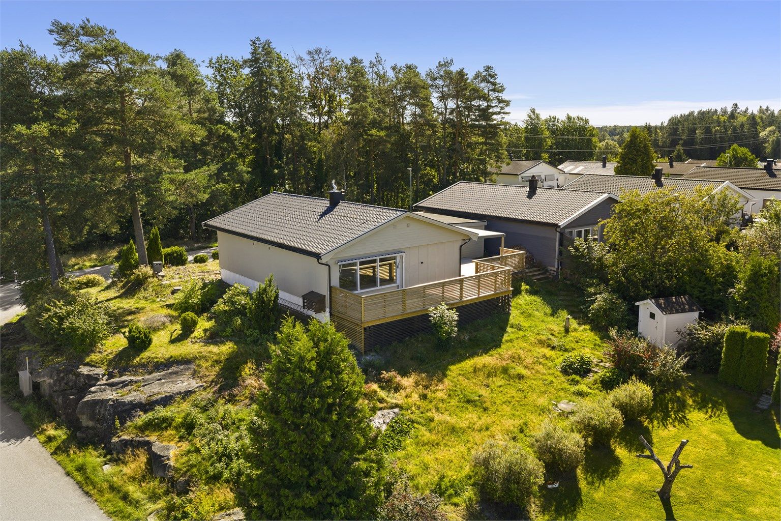 Eneboligen er oppført på en attraktiv hjørnetomt på 882 kvm., med tilstøtende bebyggelse kun i syd og vest.