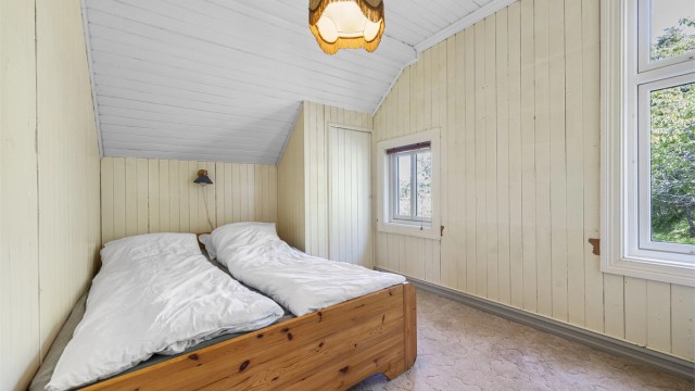 Soverom med vegg-til-vegg-teppe og plass til dobbeltseng.