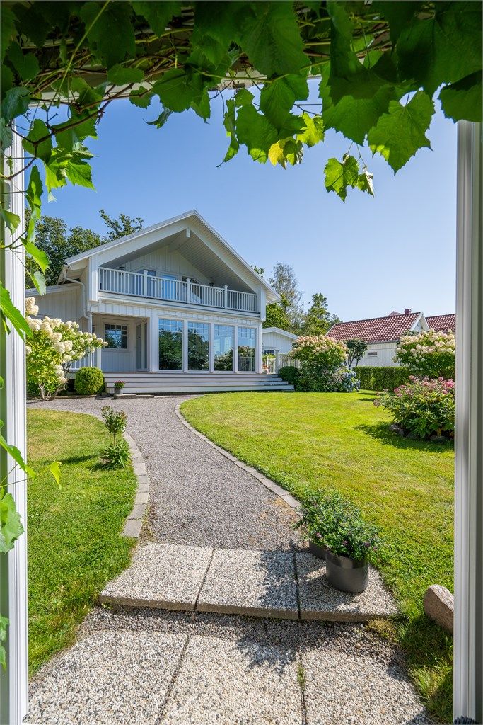 Den svingende grusstien, den idylliske sitteplassen, trappen og det harmoniske samspillet mellom grøntområder og beplantning gir eiendommen en helt spesiell karakter.