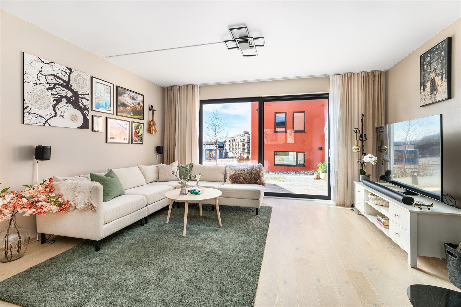 Skyve-/hevedøren gir både utsyn og enkel tilgang til terrassen. Gjennom de store glassene slipper mye naturlig dagslys inn til stuen.