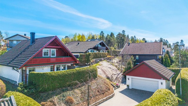 En velholdt familiebolig i et rolig og etablert villastrøk, med dobbelgarasje og en pent opparbeidet, usjenert tomt.